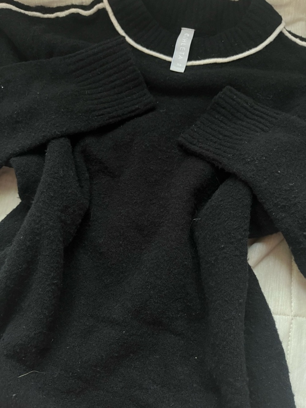 Athleta black merino wool sweater with white accents